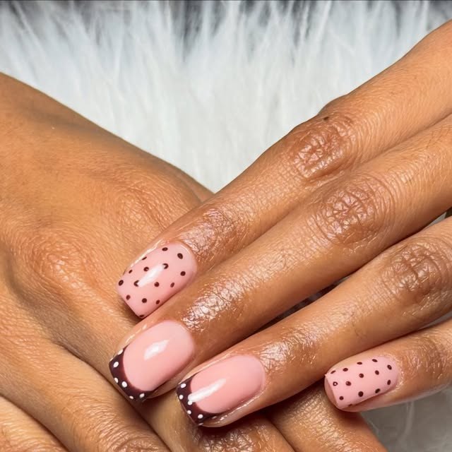 Nude pink nails with polka dots and chocolate French tips