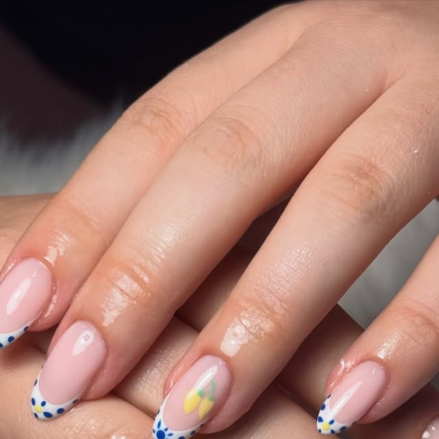 Nude nails with blue dotted French tips